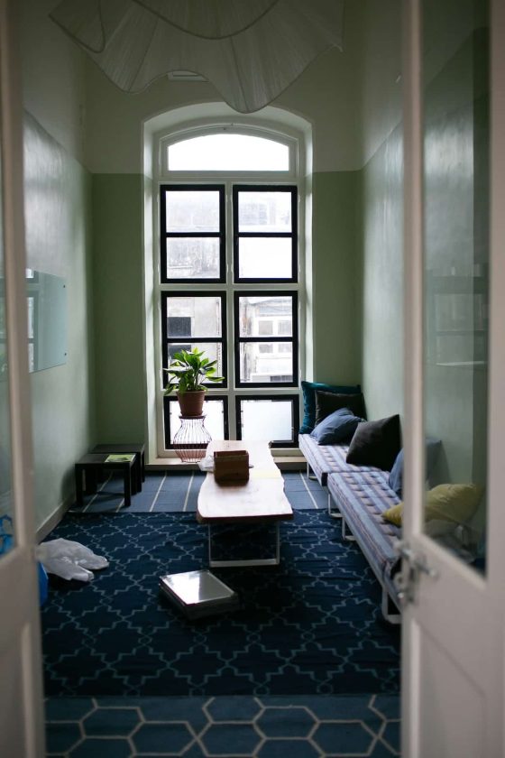 Quiet therapy office with a window seat, cushioned bench, and coffee table