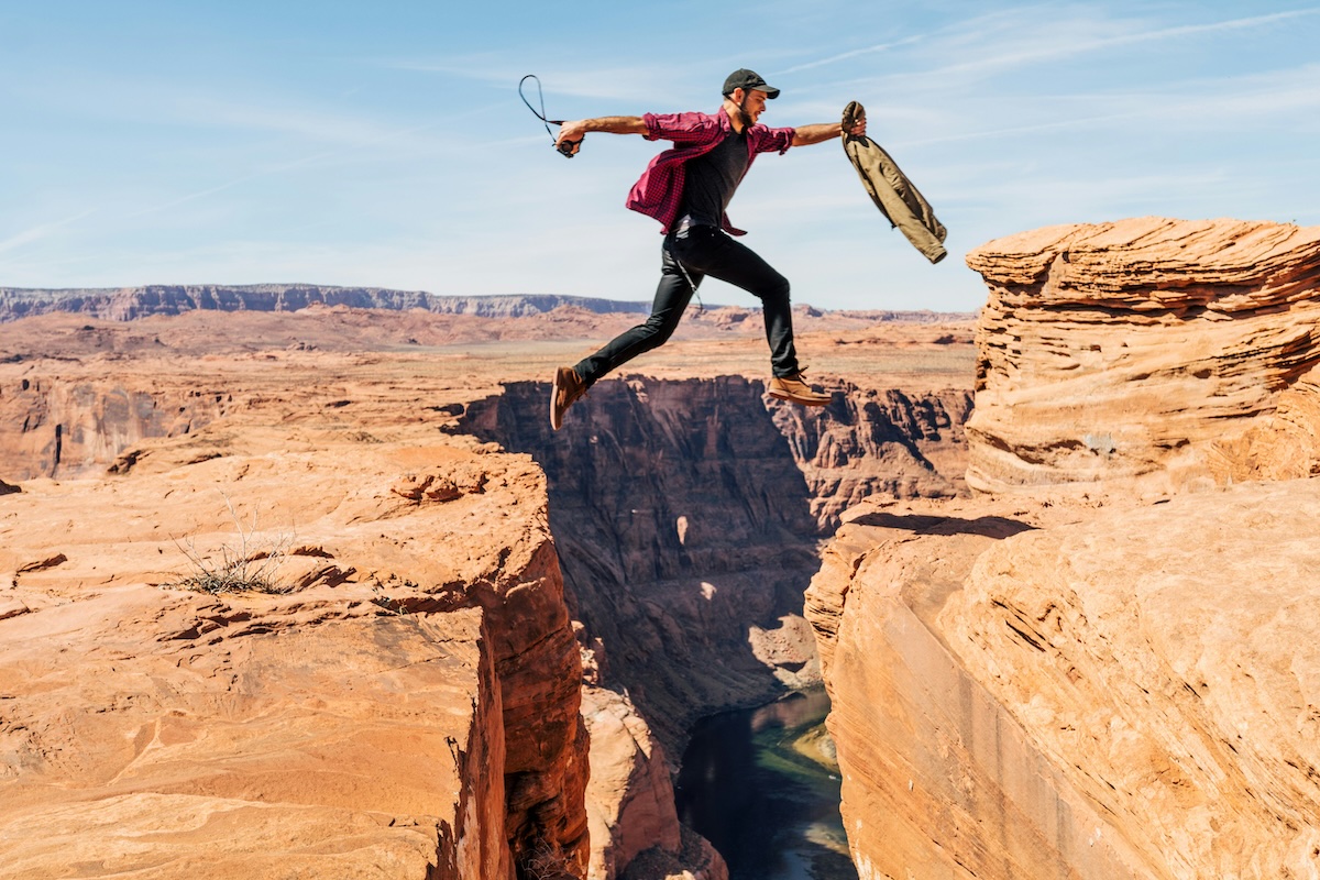 Person leaping across a canyon, symbolizing taking a courageous step toward personal change and growth