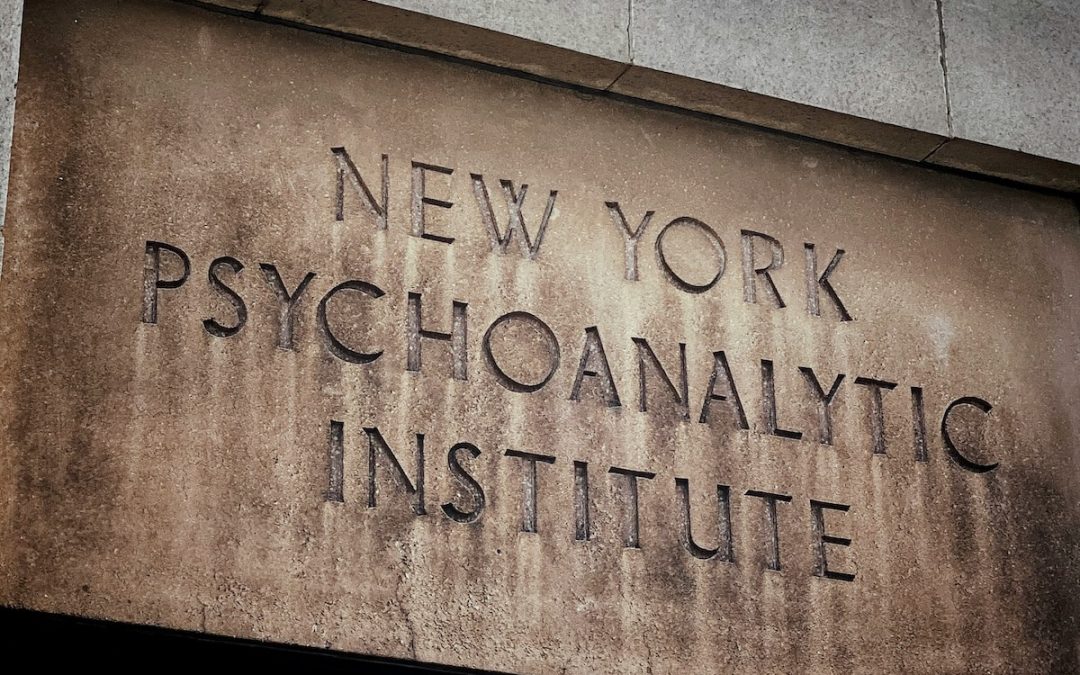 Carved stone sign reading "New York Psychoanalytic Institute" on a building facade
