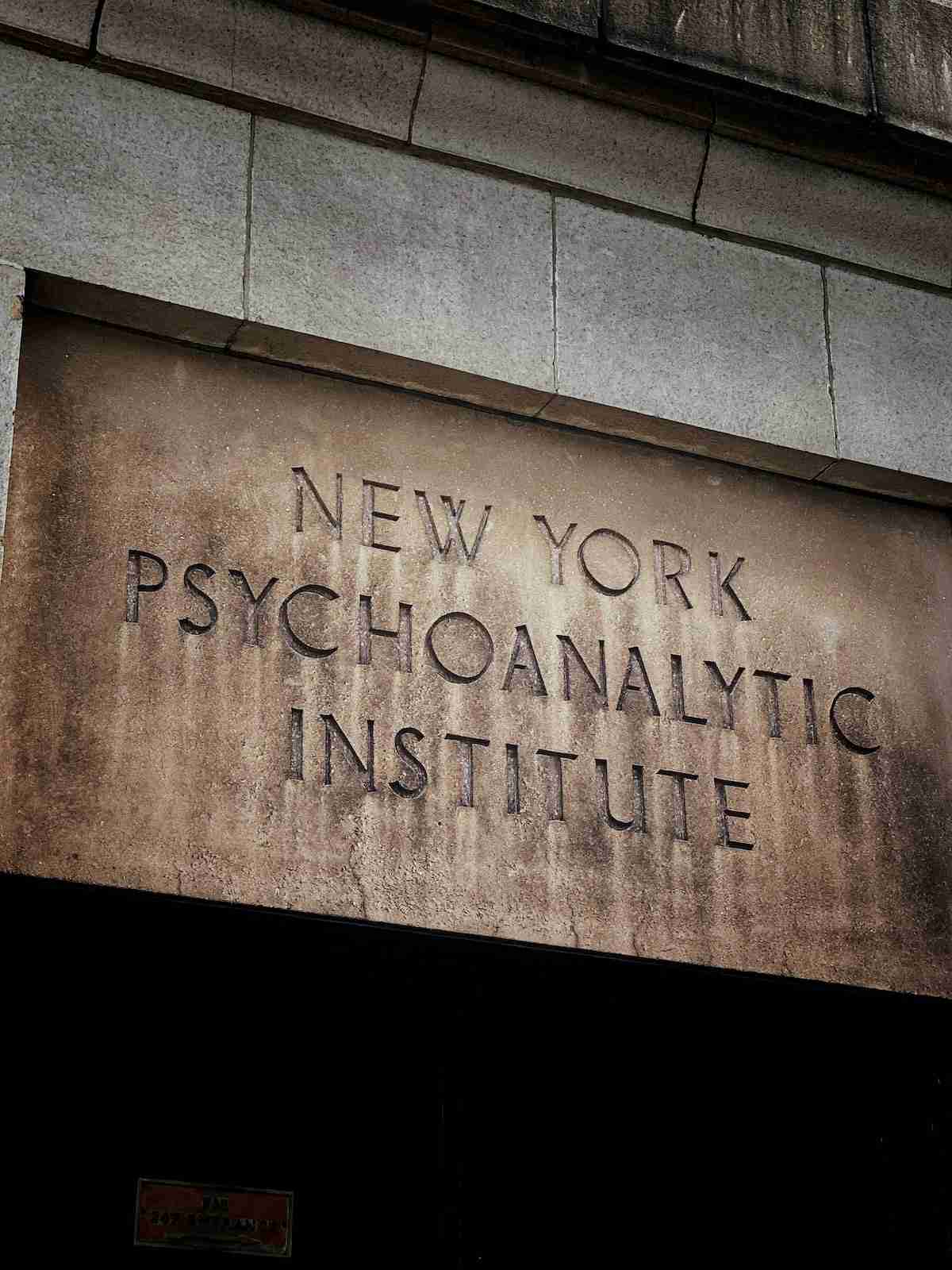 Carved stone sign reading "New York Psychoanalytic Institute" on a building facade