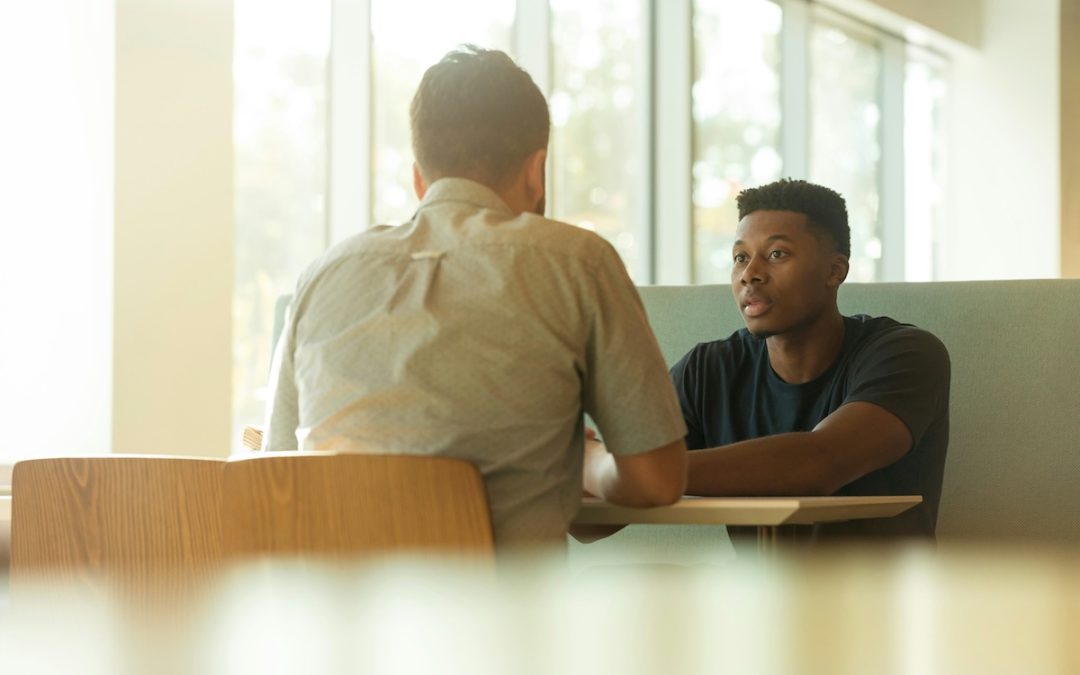 Man discussing relationship patterns and emotional attachment in a therapy setting