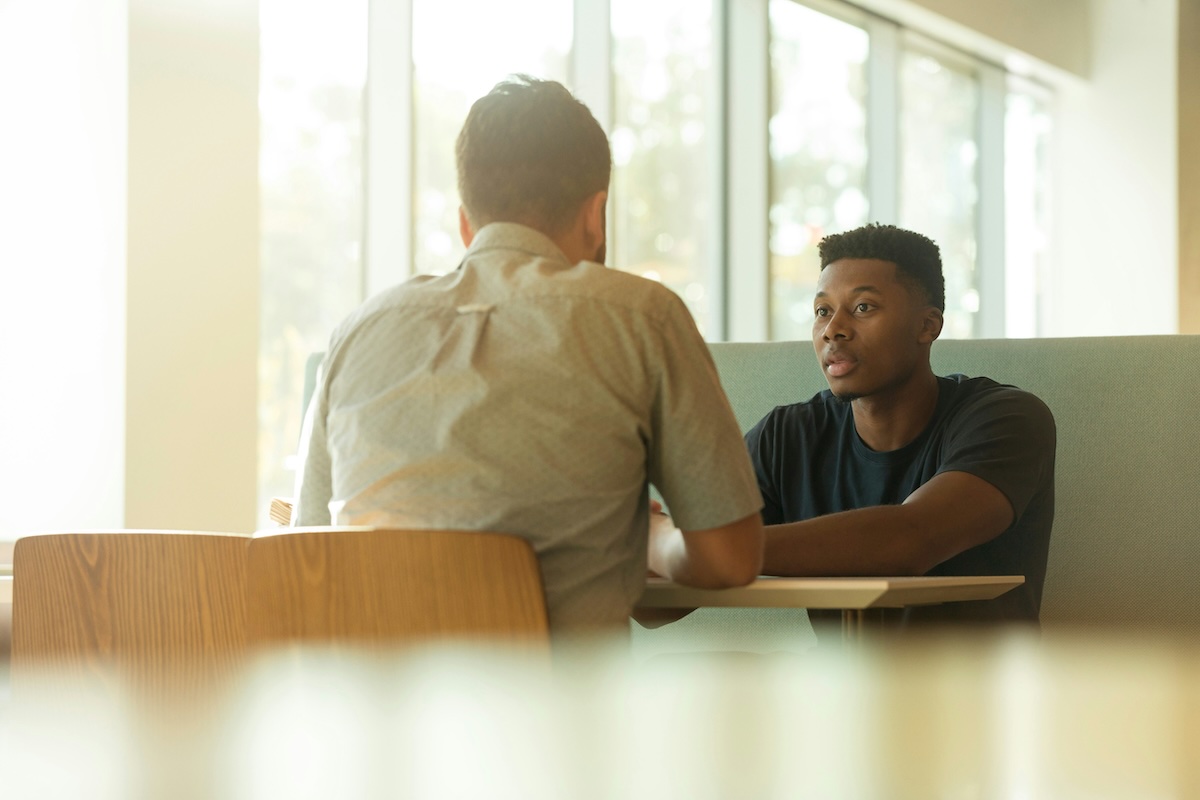 Man discussing relationship patterns and emotional attachment in a therapy setting