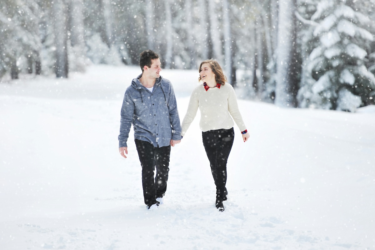 Man and woman standing together outdoors in winter, appearing emotionally distant